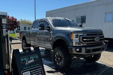 The Full Auto Detail mobile setup beside a lifted truck being washed