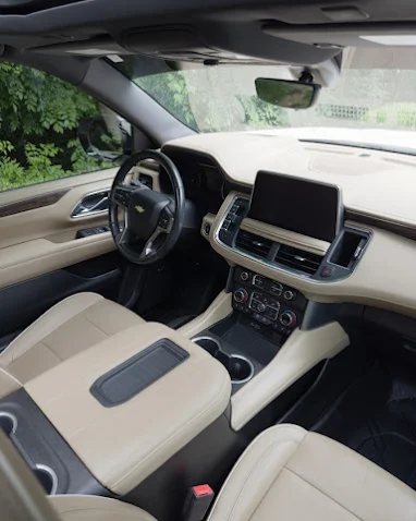 A spotless tan leather SUV interior after a full detail