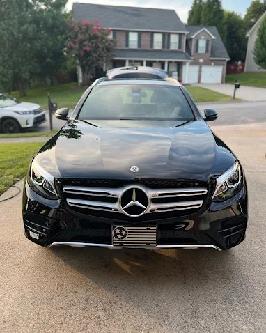 A gleaming black Mercedes SUV detailed in a driveway