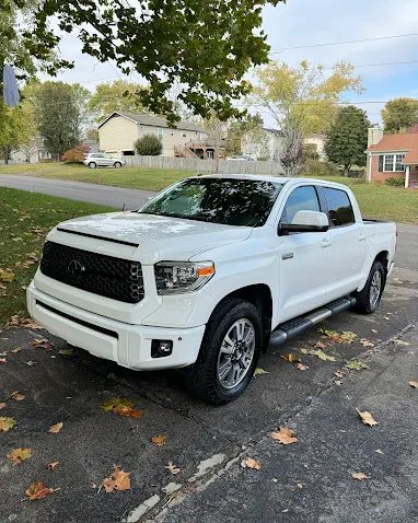 A clean white Toyota Tundra parked after detailing